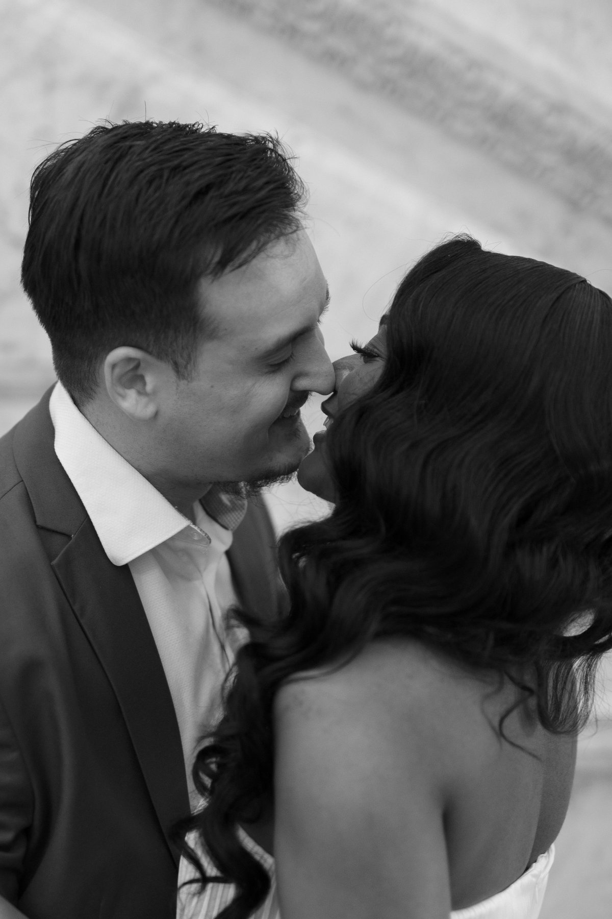 A black-and-white close-up of Marie and Matthew about to kiss